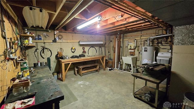 basement with a workshop area, sink, and water heater