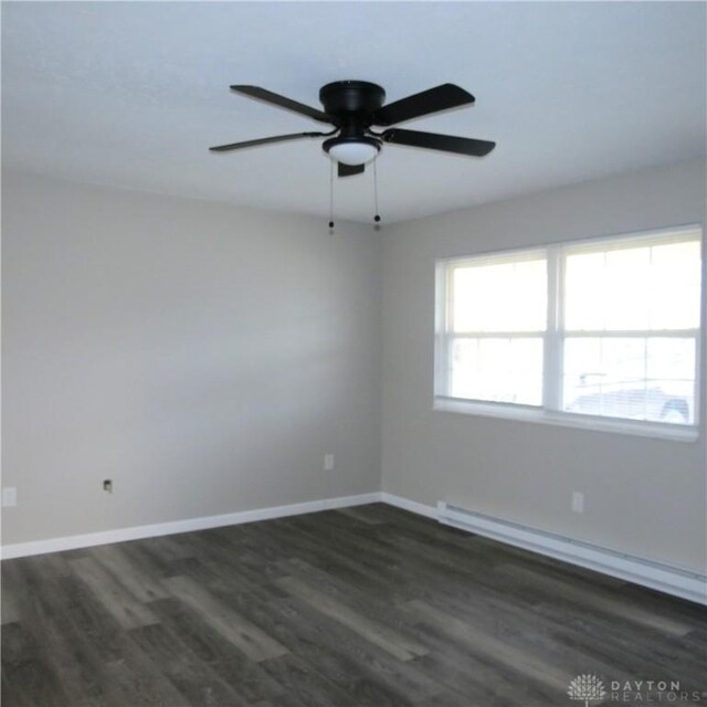 1148 Hamilton, Sidney, OH 45365 - spare room with dark wood-type flooring, ceiling fan, and baseboard heating