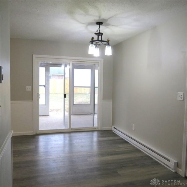 1148 Hamilton, Sidney, OH 45365 - interior space with a baseboard radiator, dark hardwood / wood-style flooring, and a chandelier