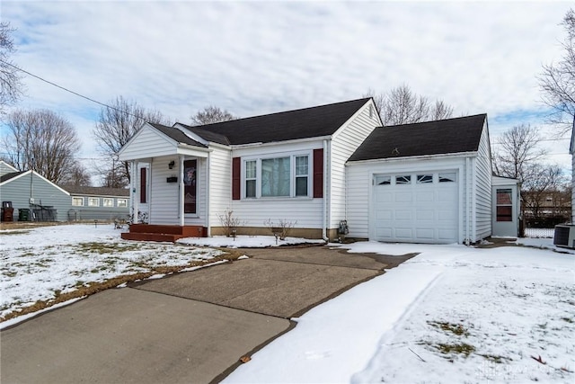 view of front of home with a garage and central AC unit