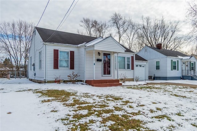 bungalow-style home with a garage and central AC unit