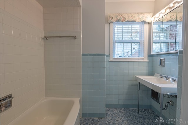 bathroom with a bath and tile walls