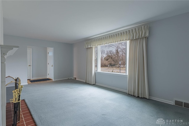 unfurnished living room with dark carpet