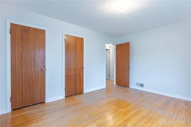 unfurnished bedroom with light hardwood / wood-style floors