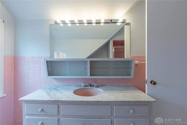 bathroom with sink and tile walls