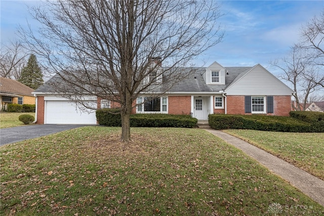 new england style home with a garage and a front yard