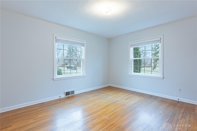 empty room with light hardwood / wood-style flooring