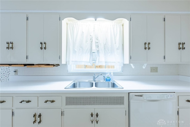 kitchen with white cabinets, decorative backsplash, sink, and dishwasher