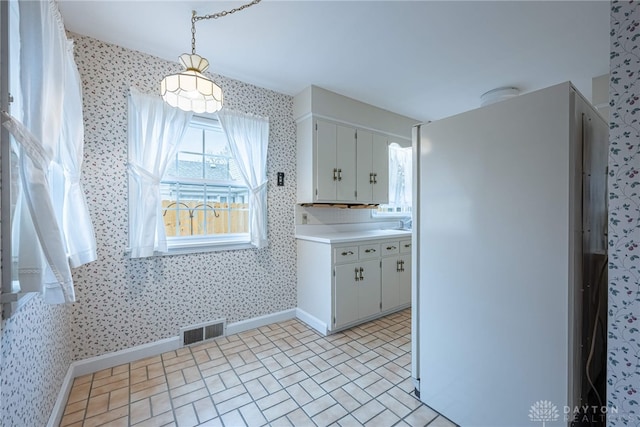 kitchen featuring white cabinets and decorative light fixtures