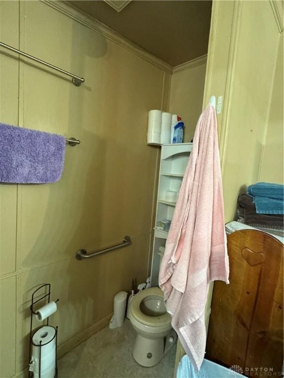 bathroom featuring ornamental molding and toilet