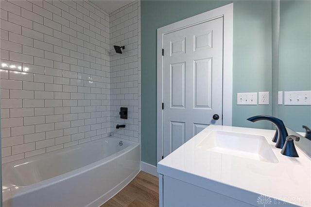 bathroom featuring vanity, tiled shower / bath combo, and wood-type flooring