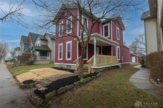 view of property exterior featuring a porch, a garage, and a yard