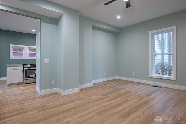 empty room featuring ceiling fan and light wood-type flooring