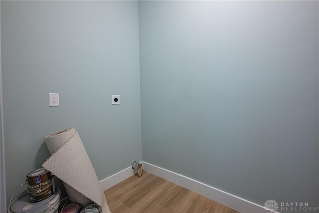 laundry room featuring hookup for an electric dryer and light hardwood / wood-style floors