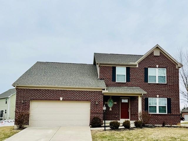 view of front of property featuring a garage and a front yard