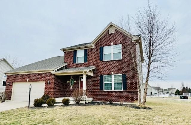 view of front property with a garage and a front lawn