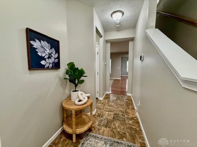 corridor with a textured ceiling