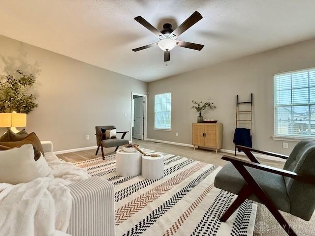 living room with light colored carpet and ceiling fan