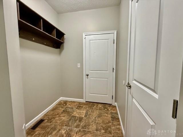 laundry area featuring a textured ceiling