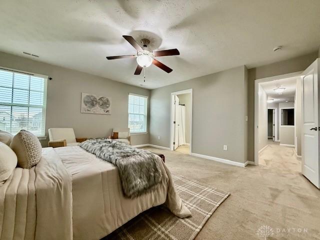 carpeted bedroom with ceiling fan