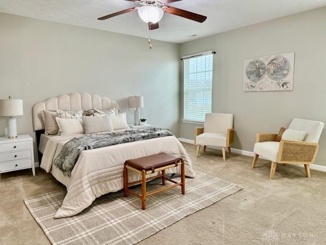 bedroom with ceiling fan and carpet flooring