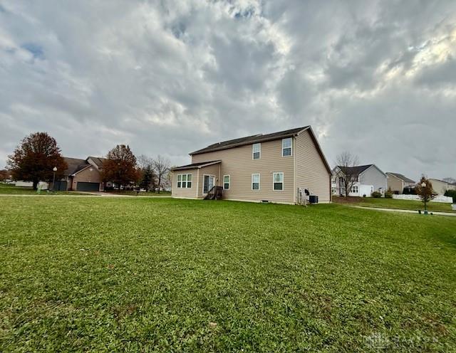 rear view of house with a yard