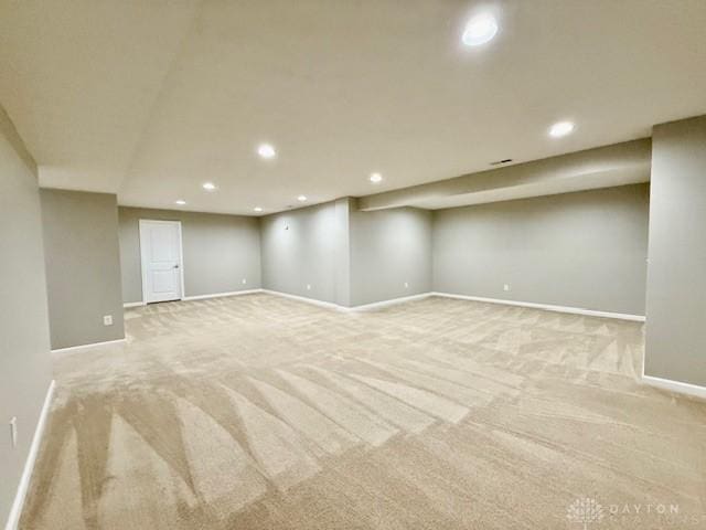 basement featuring light carpet