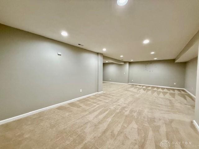 basement featuring light colored carpet