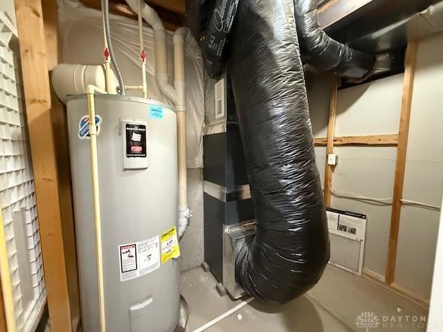 utility room featuring water heater