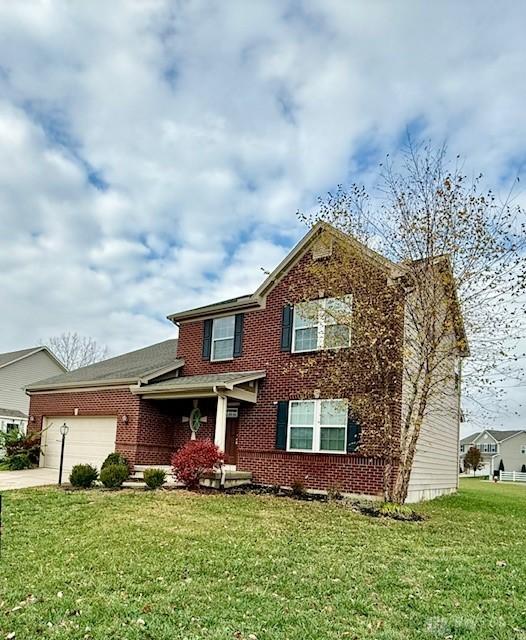 view of front of property with a garage and a front lawn