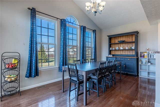 dining area with a chandelier, dark wood-style flooring, lofted ceiling, and visible vents