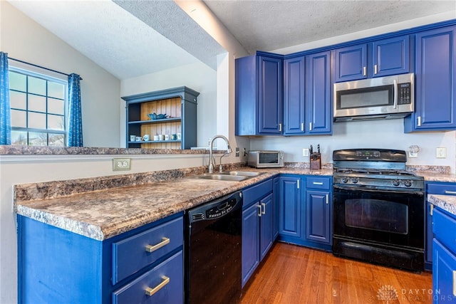 kitchen featuring blue cabinets, black appliances, and a sink