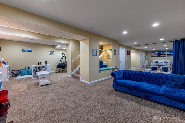 carpeted living room featuring baseboards, stairway, and recessed lighting