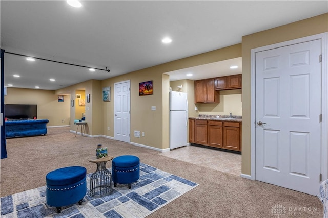 interior space with baseboards, recessed lighting, and light colored carpet