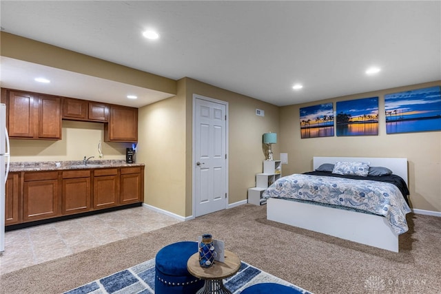 bedroom with light carpet, baseboards, a sink, and recessed lighting