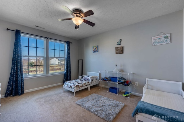 bedroom featuring a ceiling fan, light colored carpet, visible vents, and baseboards