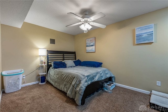 carpeted bedroom with ceiling fan and baseboards