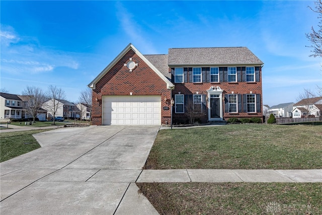 colonial inspired home with brick siding, a garage, a residential view, driveway, and a front lawn