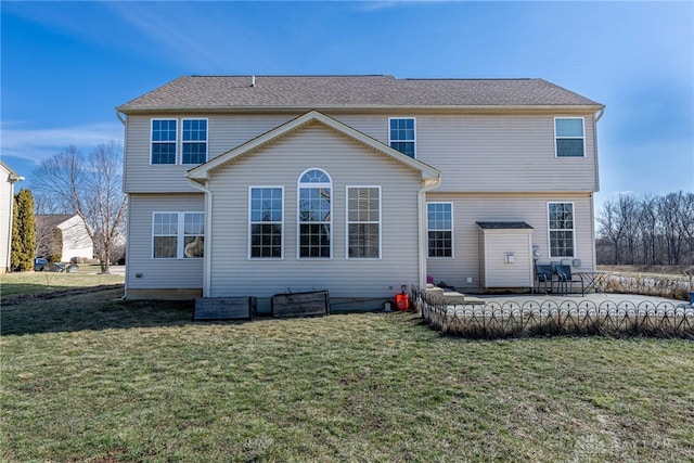 rear view of property featuring a patio area and a lawn