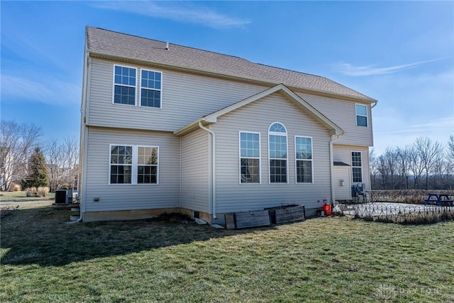 rear view of property featuring central air condition unit, a patio area, and a lawn