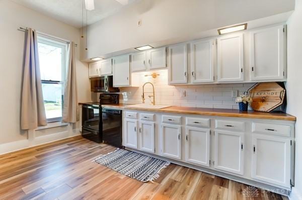 201 E Somers St, Eaton, OH 45320 - kitchen featuring range with electric stovetop, dishwashing machine, stainless steel microwave, a sink, and white cabinetry