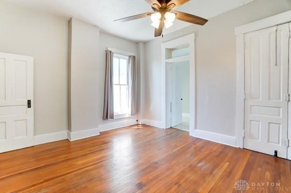 201 E Somers St, Eaton, OH 45320 - unfurnished bedroom featuring wood finished floors, baseboards, and a ceiling fan
