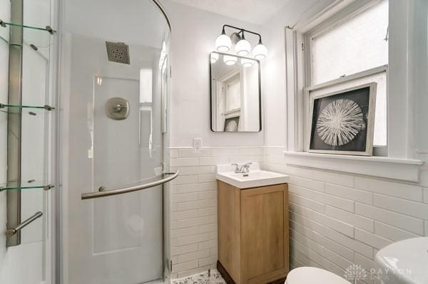 201 E Somers St, Eaton, OH 45320 - bathroom featuring a stall shower, toilet, tile walls, vanity, and wainscoting