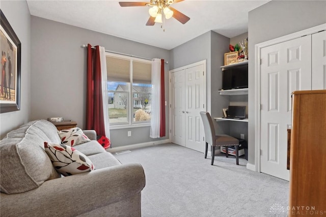 interior space with light colored carpet and ceiling fan