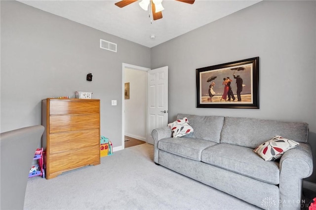 carpeted living room with ceiling fan