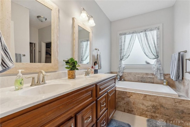 bathroom featuring vanity, tiled tub, and tile patterned floors