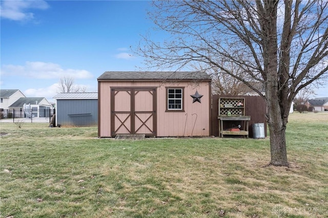 view of outdoor structure featuring a lawn