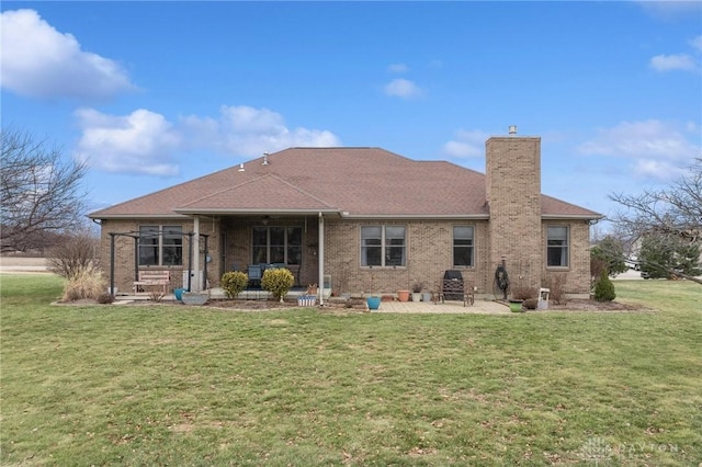 back of house with a yard and a patio