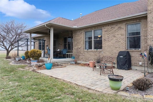 rear view of house featuring a yard and a patio area