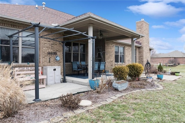 rear view of house featuring a yard and a patio